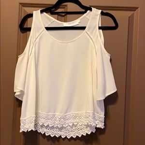 Flowy shirt with cut outs around shoulders.